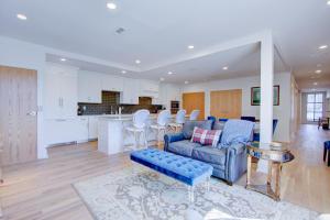 a living room with a couch and a kitchen at The Charleston Chestnut Mansion in Charleston