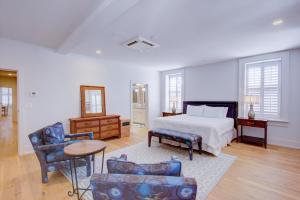 a bedroom with a bed and a table and chairs at The Charleston Chestnut Mansion in Charleston