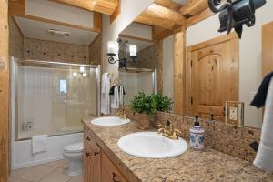 a bathroom with two sinks and a shower at The Grand Alpine Lodge in Whitefish