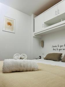 a bedroom with a bed with two pillows on it at LA TERRAZA DE LAUREL con Aire Acondicionado by Apartamentos Logrono in Logroño