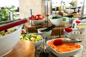 a buffet with bowls of different types of food at Hotel Carretero in Manizales