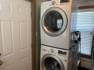 una lavatrice e un'asciugatrice in una stanza accanto a una porta di Walker's Place a Outback Mobile Home Settlement