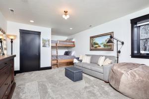 a living room with a couch and a bed at Whispering Pines Chalet in Whitefish