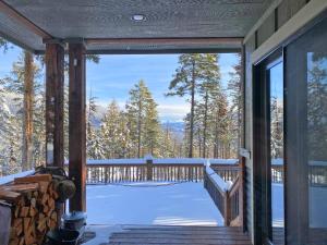 a screened in porch with snow on the ground at Whispering Pines Chalet in Whitefish