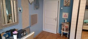 a room with blue walls and a white door at Queen house apartman in Zagreb