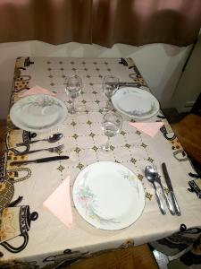 una mesa con platos y copas de vino. en Terrazas Ushuaia en Ushuaia