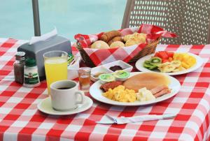 a table with plates of food and a basket of food at Hotel Atlantic Lux in Cartagena de Indias