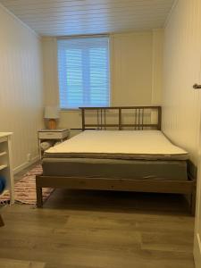 a bedroom with a bed in a room with a window at New 2 bed room apartment in Halden in Halden