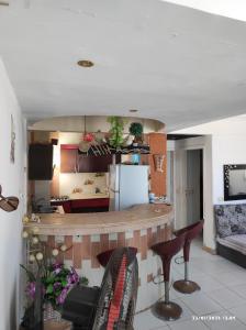 a kitchen with a counter and some chairs in a room at roof in Marsa Alam in Marsa Alam City