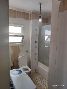 a small bathroom with a toilet and a sink at roof in Marsa Alam in Marsa Alam City