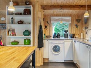 a kitchen with a washing machine and a window at 8 person holiday home in Holb k in Holbæk