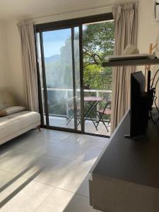 sala de estar con una gran puerta corredera de cristal y balcón en Federal 498 en La Rioja