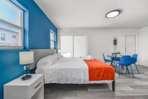 a blue and white bedroom with a bed and a table at Beachfront Getaway Studio with Parking - M21 in Hollywood