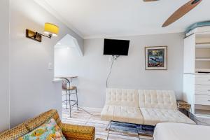 - un salon avec un canapé et une télévision murale dans l'établissement Beachview 208, à Gulf Shores
