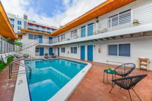 a swimming pool in the backyard of a building at Beachfront Getaway Studio with Parking - M21 in Hollywood