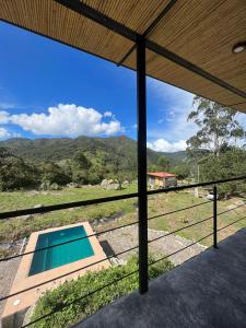 a view from the porch of a house with a swimming pool at Santa Helena in Chinácota