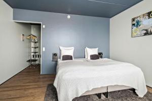 Best Western Royal Holstebro في هولستيبرو: غرفة نوم بسرير كبير بجدران زرقاء