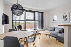 a living room with a table and a couch at Best Western Royal Holstebro in Holstebro