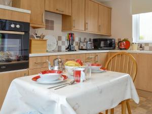 a kitchen with a table with plates and bowls of food at Westcliff in Whitehills