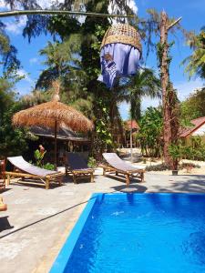 a resort with a swimming pool and a beach at The Mellow Mango in Ko Lanta