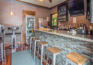 a bar in a restaurant with stools at Hotel Dushore in Dushore