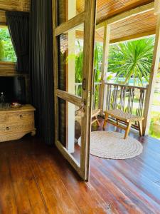 an open door to a porch with a chair and a television at Villa Bali Santai in Kerobokan +23 photos