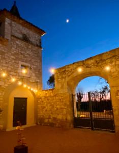 an entrance to a stone building at night at DOMAINE DE LEJOS - Portes d'Albi in Lamillarié