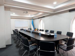 a large conference room with a long table and chairs at Reikartz Amirun Tashkent in Tashkent