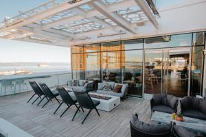 a patio with chairs and tables and a view of the ocean at LUMA Hotel San Francisco in San Francisco