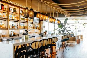 a bar with a bunch of stools in a restaurant at LUMA Hotel San Francisco in San Francisco +36 photos