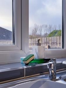 a kitchen counter with a sink and a window at The Fairfield - Free Parking & Wi-Fi - 5min to Freeman Hospital in Longbenton