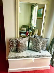 a couch with pillows in front of a mirror at The Quay in Newhaven