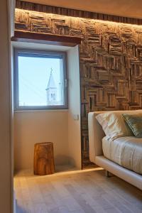 a living room with a window and a couch at One Suite in San Marino