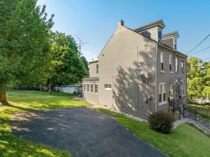 a house with a driveway in front of it at Rare City Home w/ Backyard Fire-pit & Hottub in Lancaster