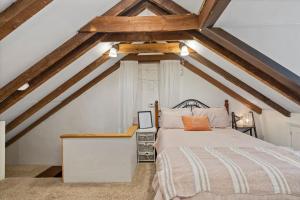 a bedroom with a bed in a attic at Rare City Home w/ Backyard Fire-pit & Hottub in Lancaster