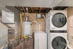 a laundry room with a washing machine and a washer at Rare City Home w/ Backyard Fire-pit & Hottub in Lancaster