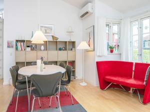 a dining room with a table and red chairs at 6 person holiday home in Aabenraa-By Traum in Aabenraa +21 photos