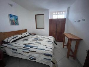 a bedroom with a bed and a table and a mirror at JericóHouse apto 202 in Jericó