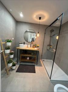 a bathroom with a shower and a sink and a mirror at Luxury Artistic Digital Nomad Getaway w/ Terrace in Lisbon