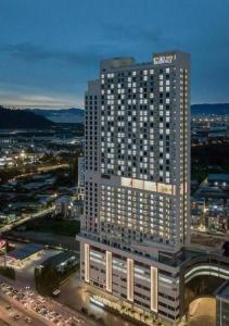 a tall building with lights on in a city at 【NEW】Cozy&Warm Studio@Juru Sentral Icon City in Bukit Mertajam