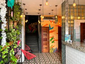 a corridor of a restaurant with colorful walls and stairs at Canova in Panama City