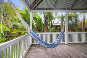 a hammock on the porch of a house at The Ultimate Holiday Retreat Pets Welcome in Tea Gardens