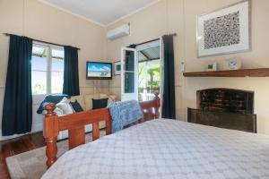a bedroom with a bed and a fireplace at The Ultimate Holiday Retreat Pets Welcome in Tea Gardens