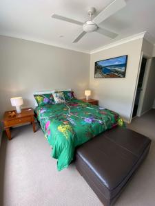 a bedroom with a bed and a ceiling fan at Farm Stay at Camellia Cottage pet friendly in Picton