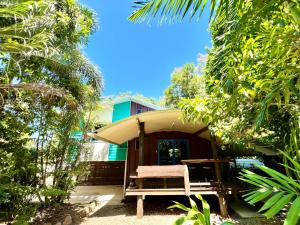 a chair sitting in front of a house at Kwila Cottage in Mission Beach