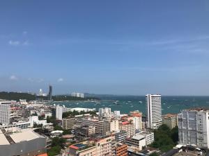 an aerial view of a city with buildings and water at Many Holiday The Base Condo in Pattaya Central