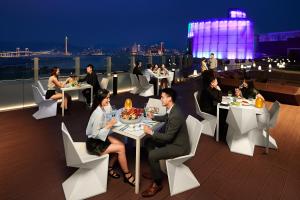 a group of people sitting at tables on a roof at Altira Macau in Macau