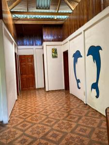 a hallway with dolphins painted on the walls of a building at Betania House in Drake