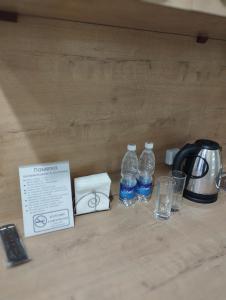 a table with two bottles of water and glasses at Pravda in Bishkek