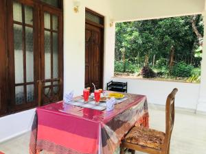 a table with a plate of food on it at Holly Flowers Villa in Sigiriya +26 photos